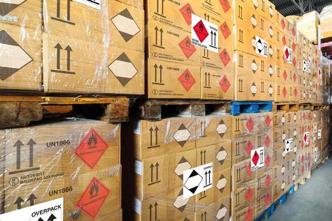 Palletized DG cargo with UN hazard labels, shrink-wrapped for export shipment